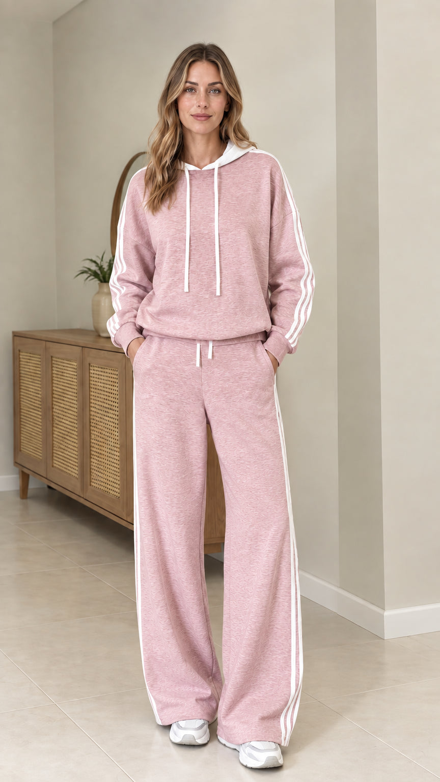 Model wearing Dusty Pink two-piece tracksuit set with white side stripes