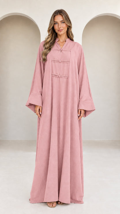 Front view of model wearing dusty pink long sleeve modest abaya dress