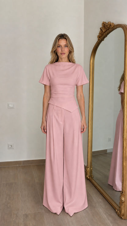 Front view of woman wearing pink matching top and wide-leg pants