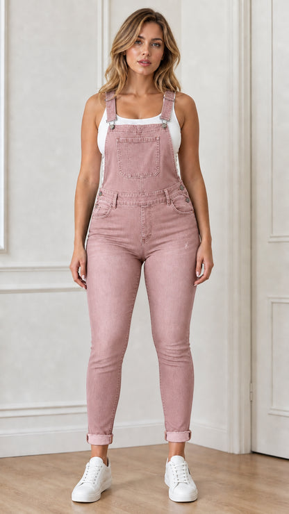 Front view of woman wearing pink denim overalls