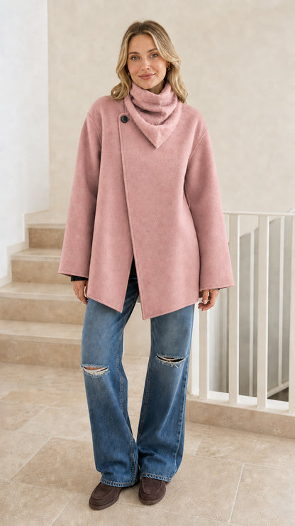 Front view of woman wearing pink asymmetrical cowl neck jacket