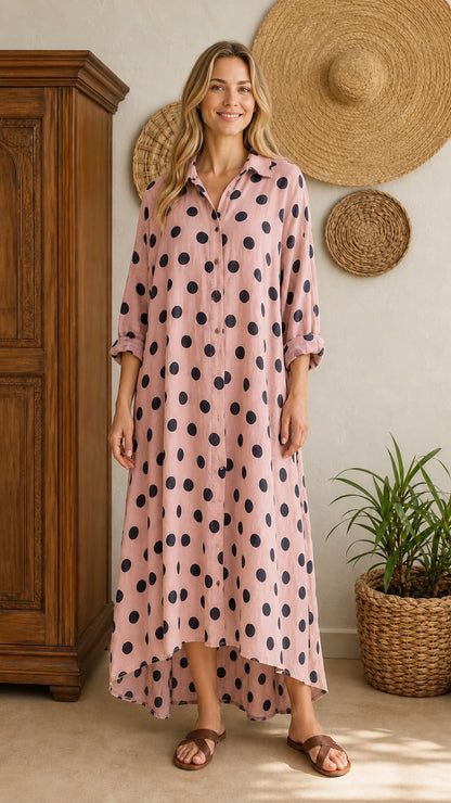 Front view of pink polka dot maxi shirt dress on model