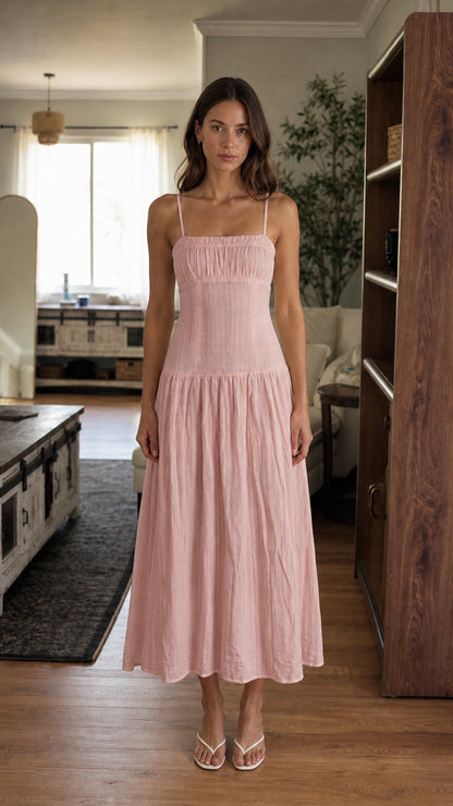 Woman wearing pink smocked midi dress