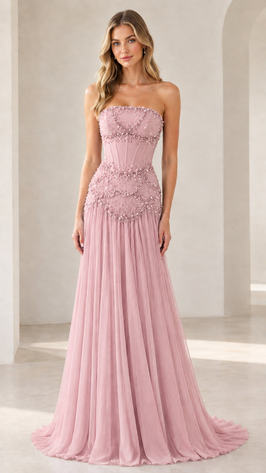 Model wearing blush pink strapless beaded corset formal gown