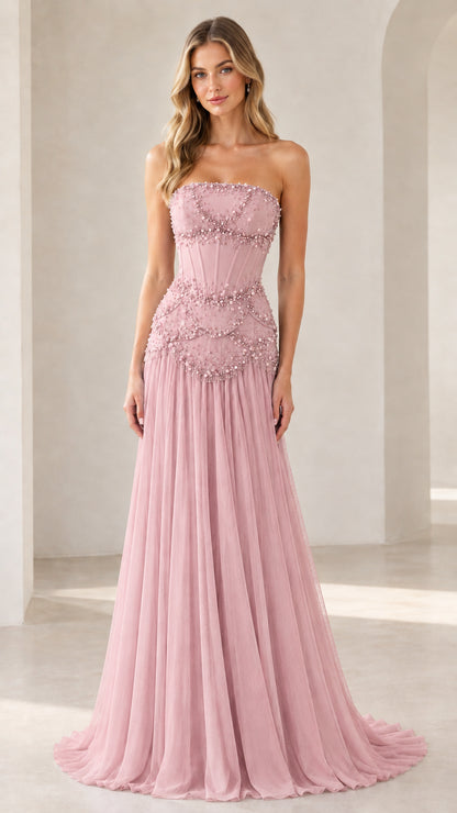 Model wearing blush pink strapless beaded corset formal gown