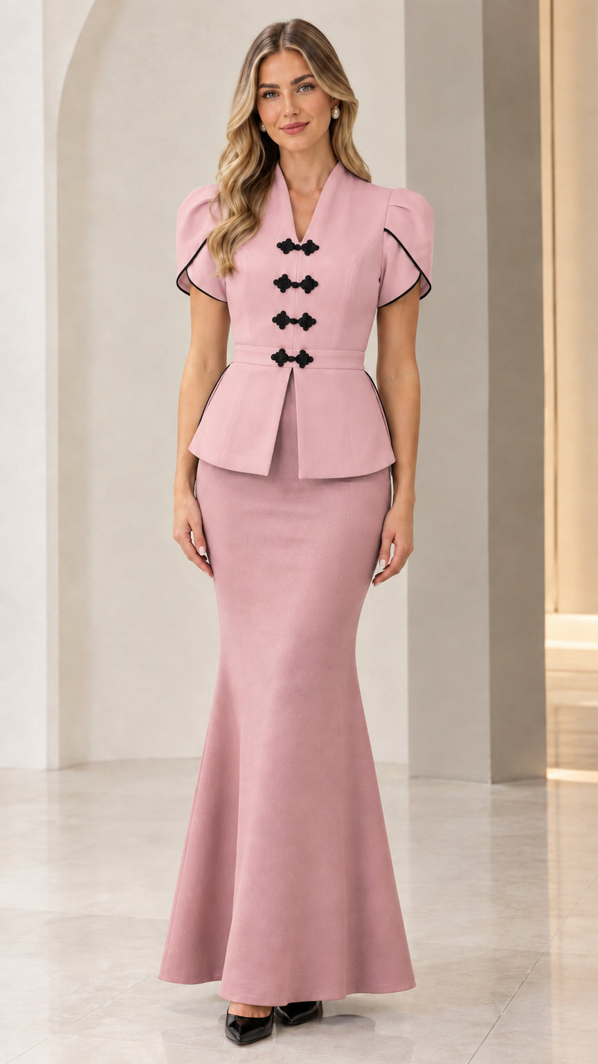 Front full view of woman wearing dusty pink peplum top and matching mermaid maxi skirt set