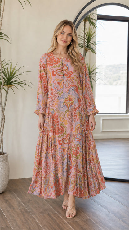 Front view of woman wearing pink multi bohemian print tiered maxi dress