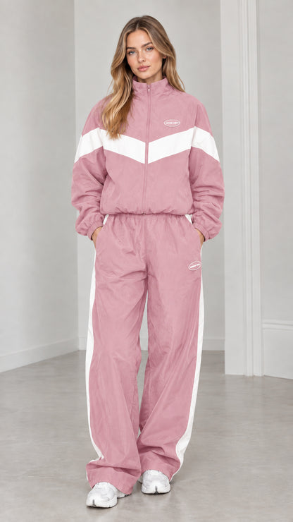 Full length view of woman wearing dusty pink and white colorblock tracksuit set