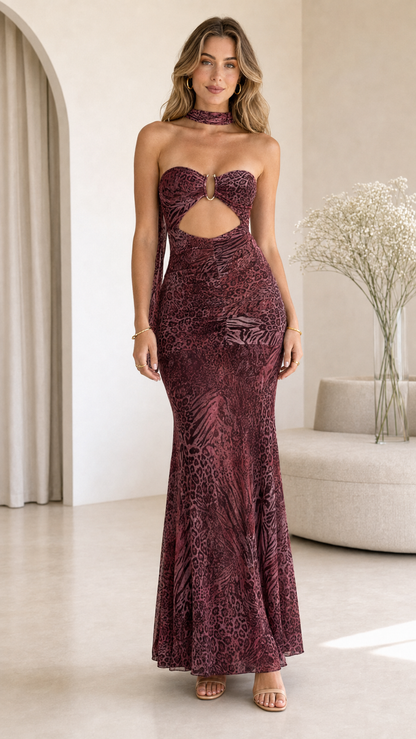 Model wearing burgundy animal print strapless cutout maxi dress front view