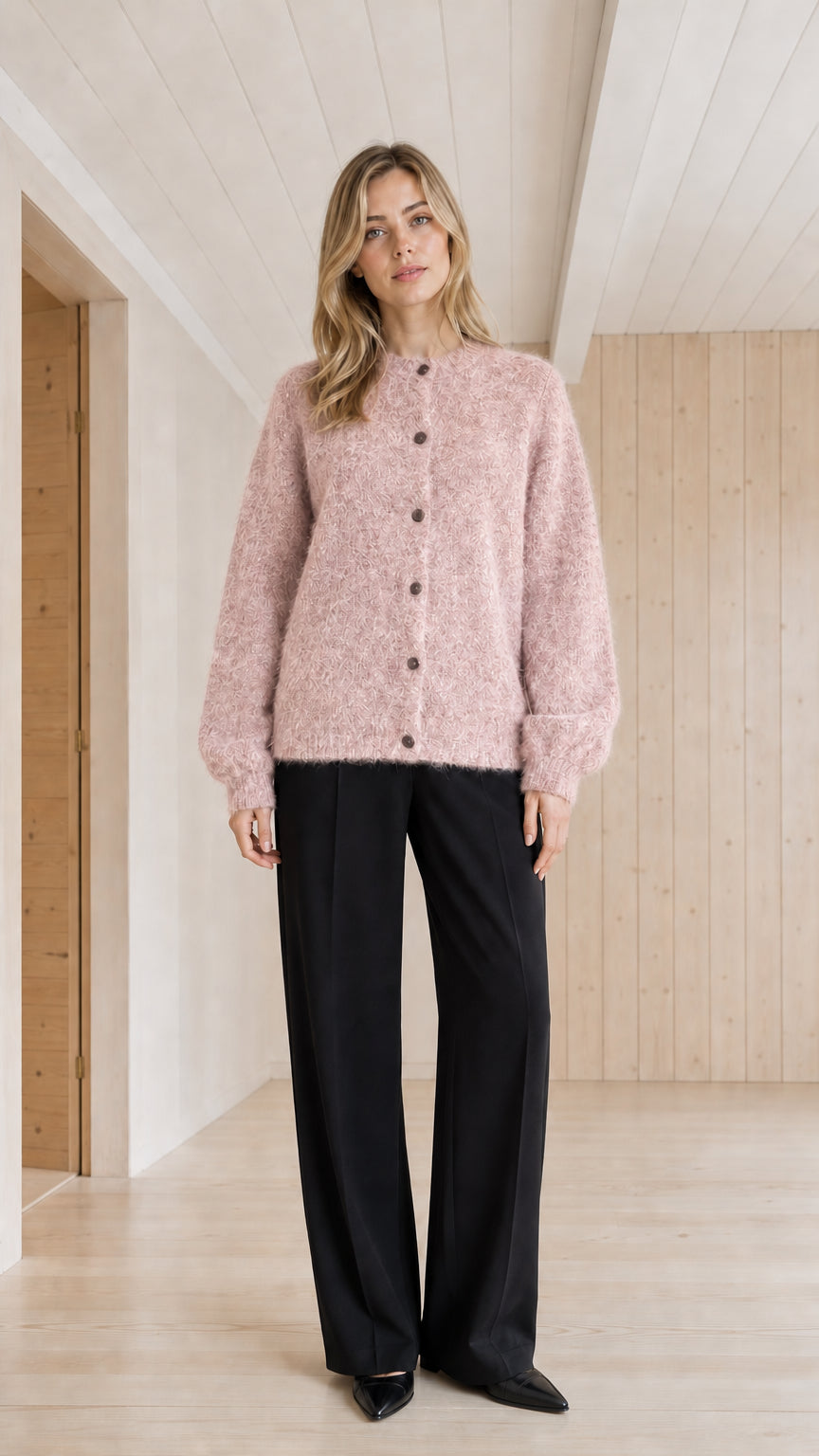 Model wearing blush pink fuzzy crewneck button-front cardigan sweater