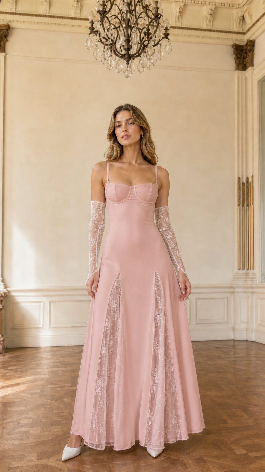 Model wearing blush pink bustier evening gown with lace skirt details