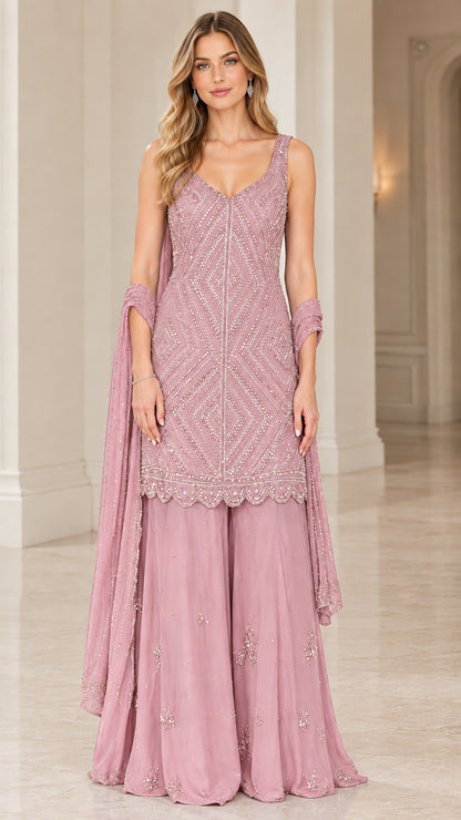 Model wearing Dusty Pink beaded kurti sharara suit set with sheer dupatta