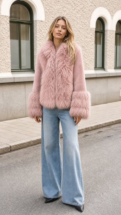 Model wearing dusty pink faux fur trimmed jacket with denim trousers