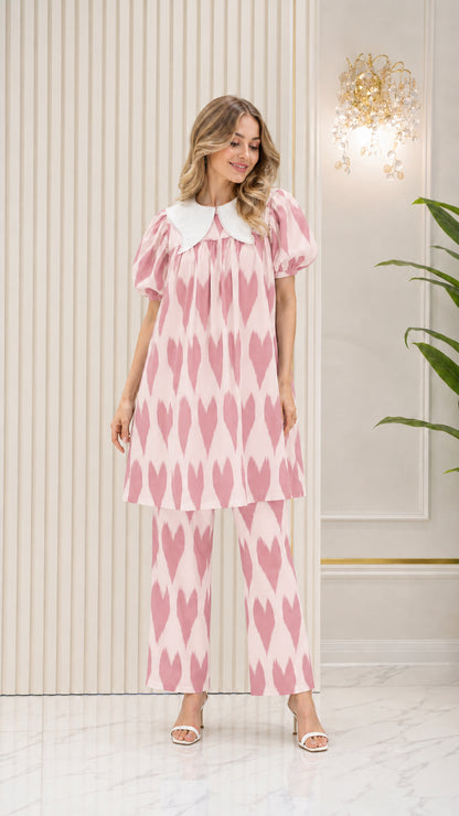 Model wearing Blush Pink geometric pattern tunic top and trouser set