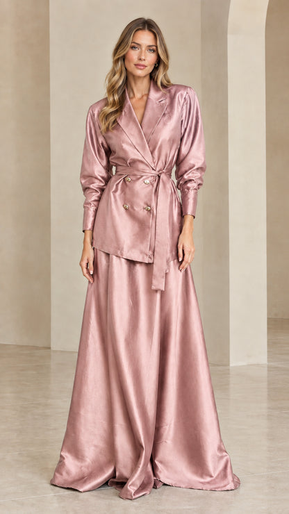 Woman wearing dusty rose pink satin blazer and maxi skirt set