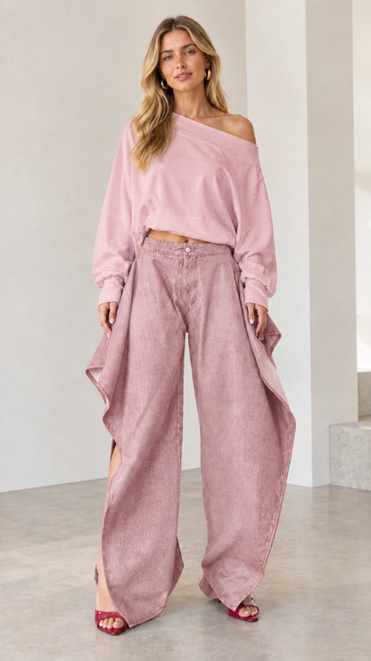 Full front view of monochromatic dusty pink draped wide-leg denim jeans and matching pink pullover