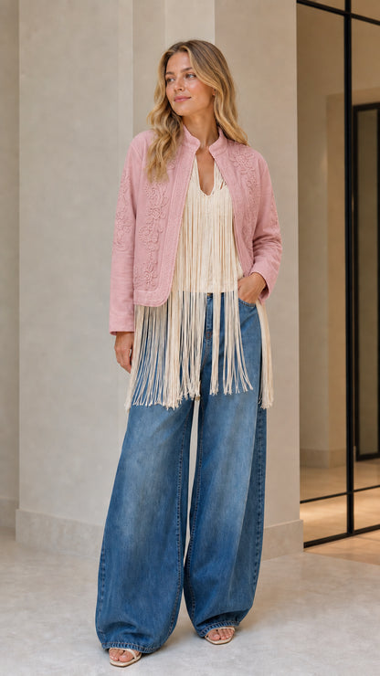 Model wearing pink embroidered fringe jacket