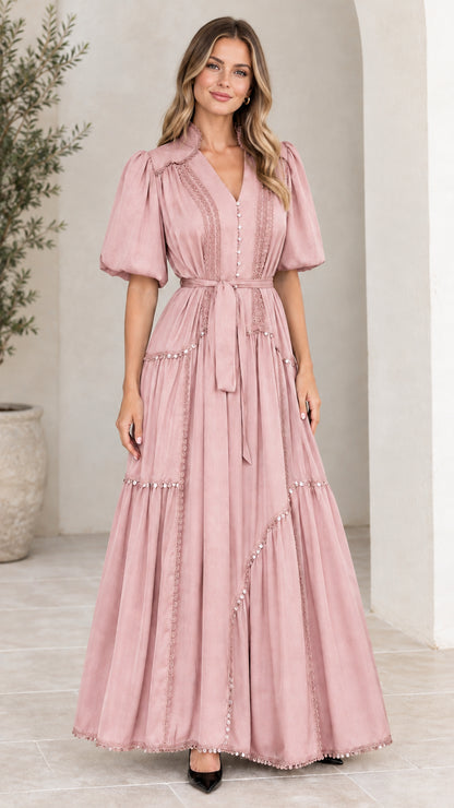 Front view of woman wearing dusty pink V-neck tiered maxi dress with puff sleeves