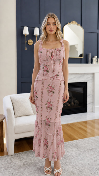 Front view of woman wearing pink floral midi dress