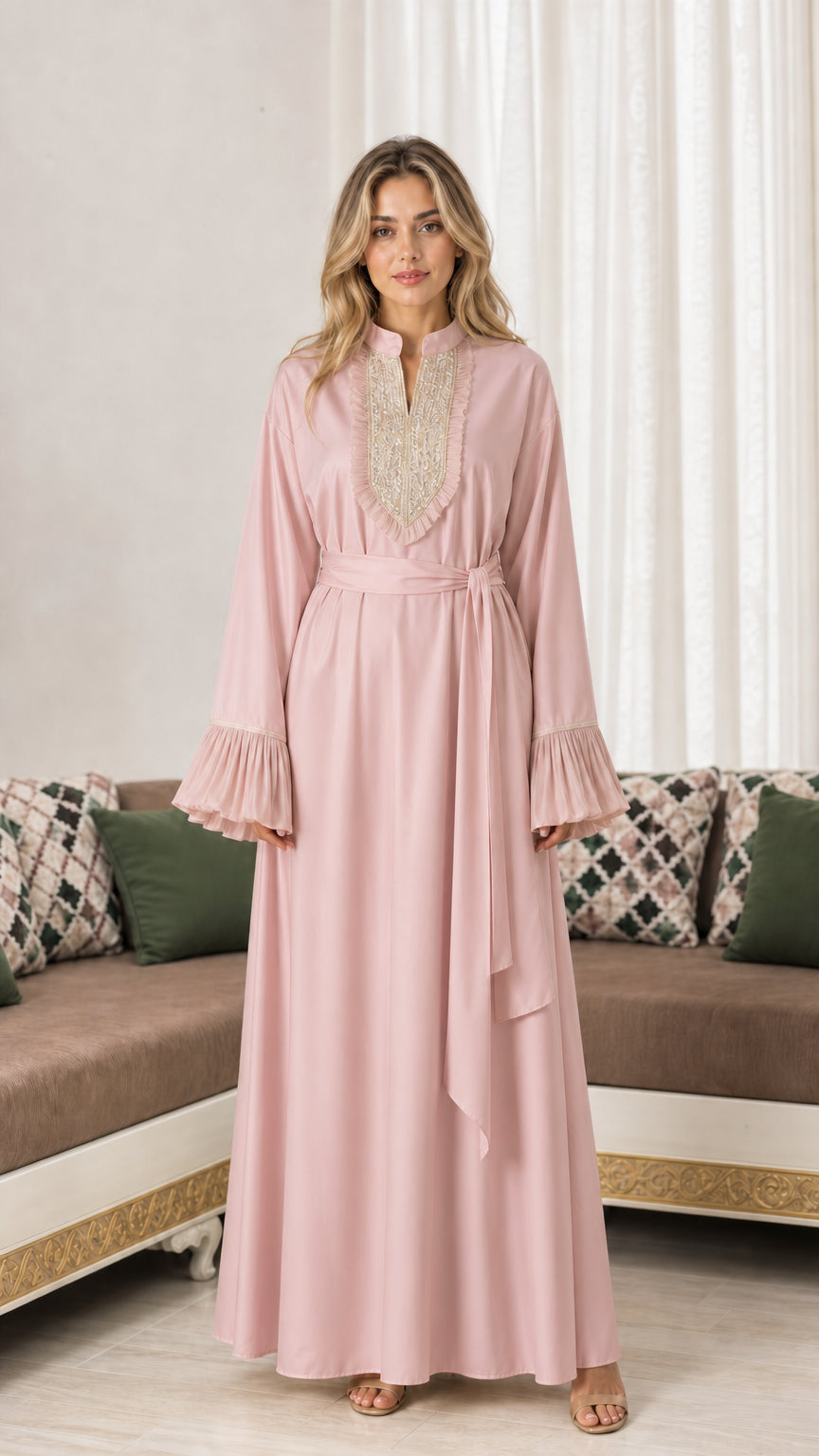 Front view of woman wearing dusty pink embroidered maxi abaya dress with tie belt