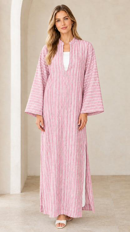 Woman wearing pink vertical striped maxi kaftan dress