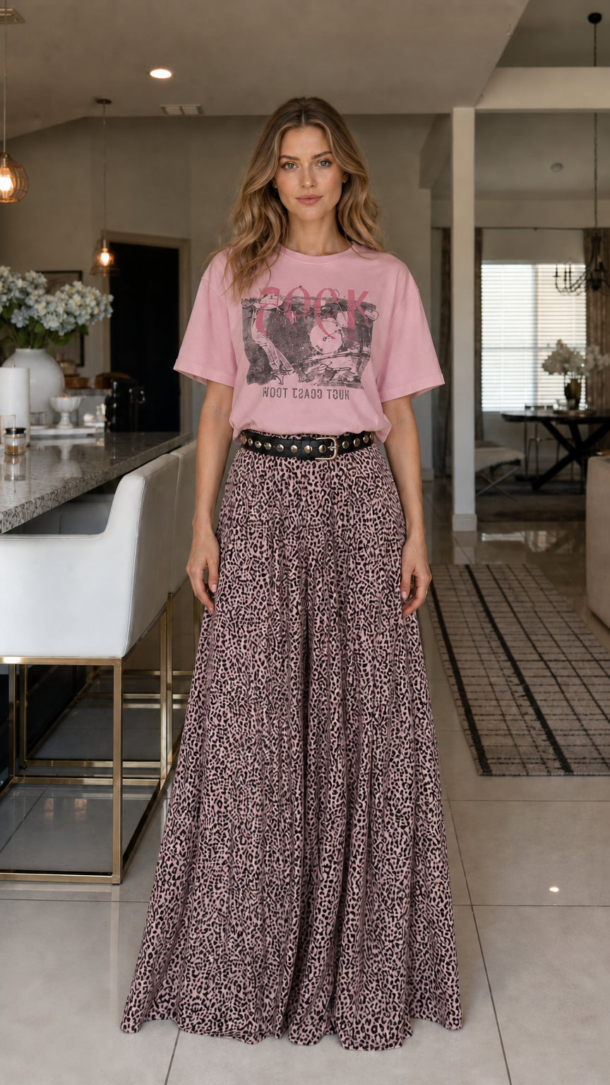 Model wearing pink graphic tee and leopard print pants
