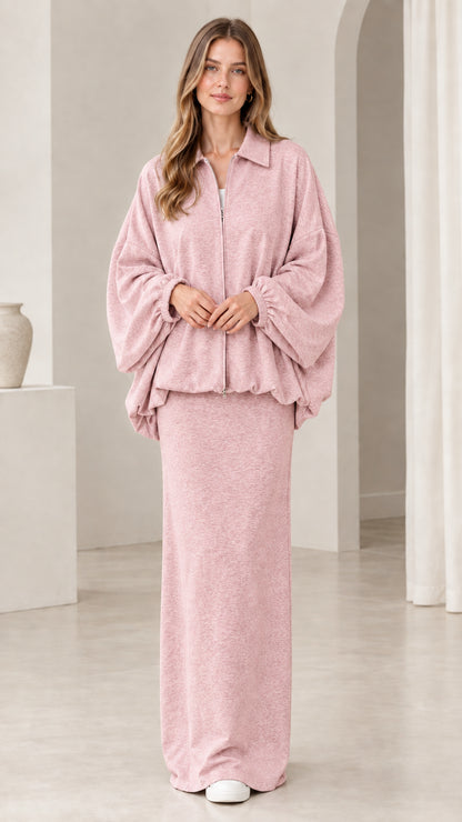 Model wearing dusty pink zip jacket and matching column maxi skirt set