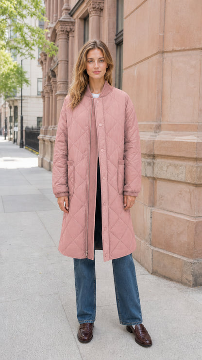 Front view of model wearing dusty pink longline quilted bomber coat