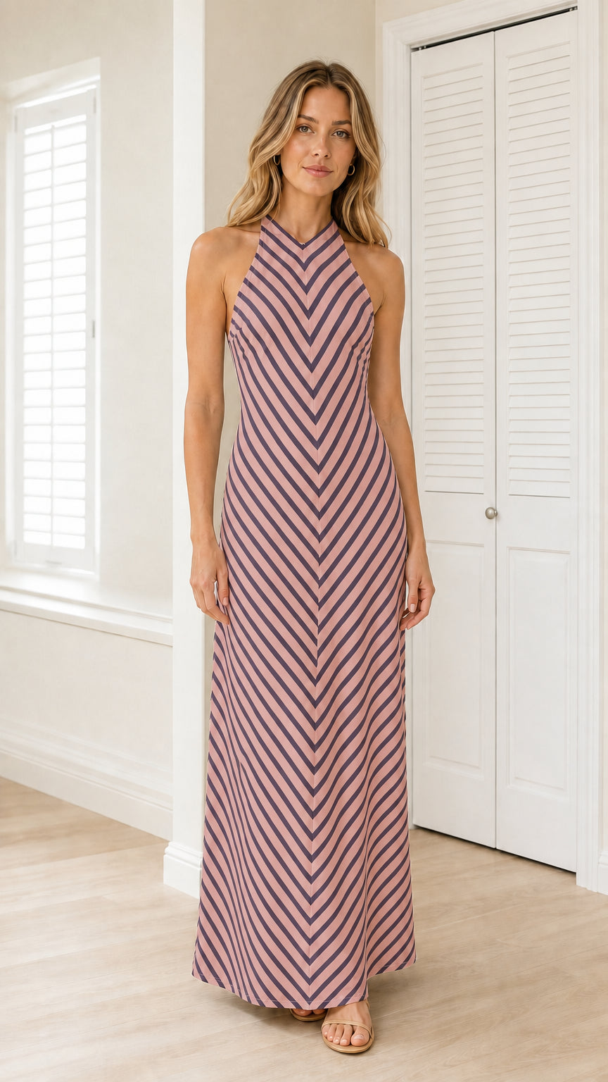 Front view of model wearing dusty pink striped halter maxi dress