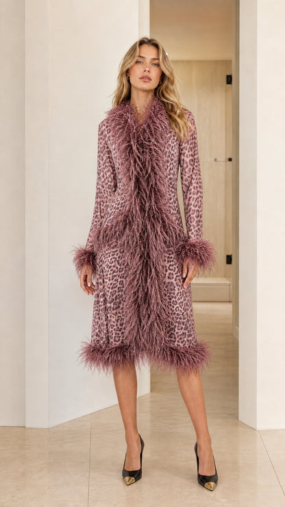 Model wearing the dusty rose pink leopard print midi coat with mauve feather trim