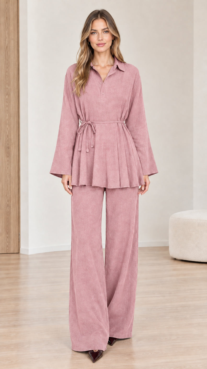 Front view of woman wearing dusty pink belted peplum top and wide-leg pants set