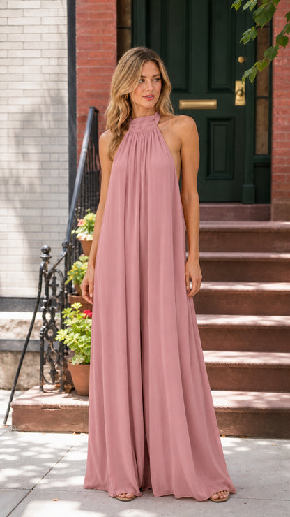 Woman wearing dusty pink halter neck wide leg backless jumpsuit