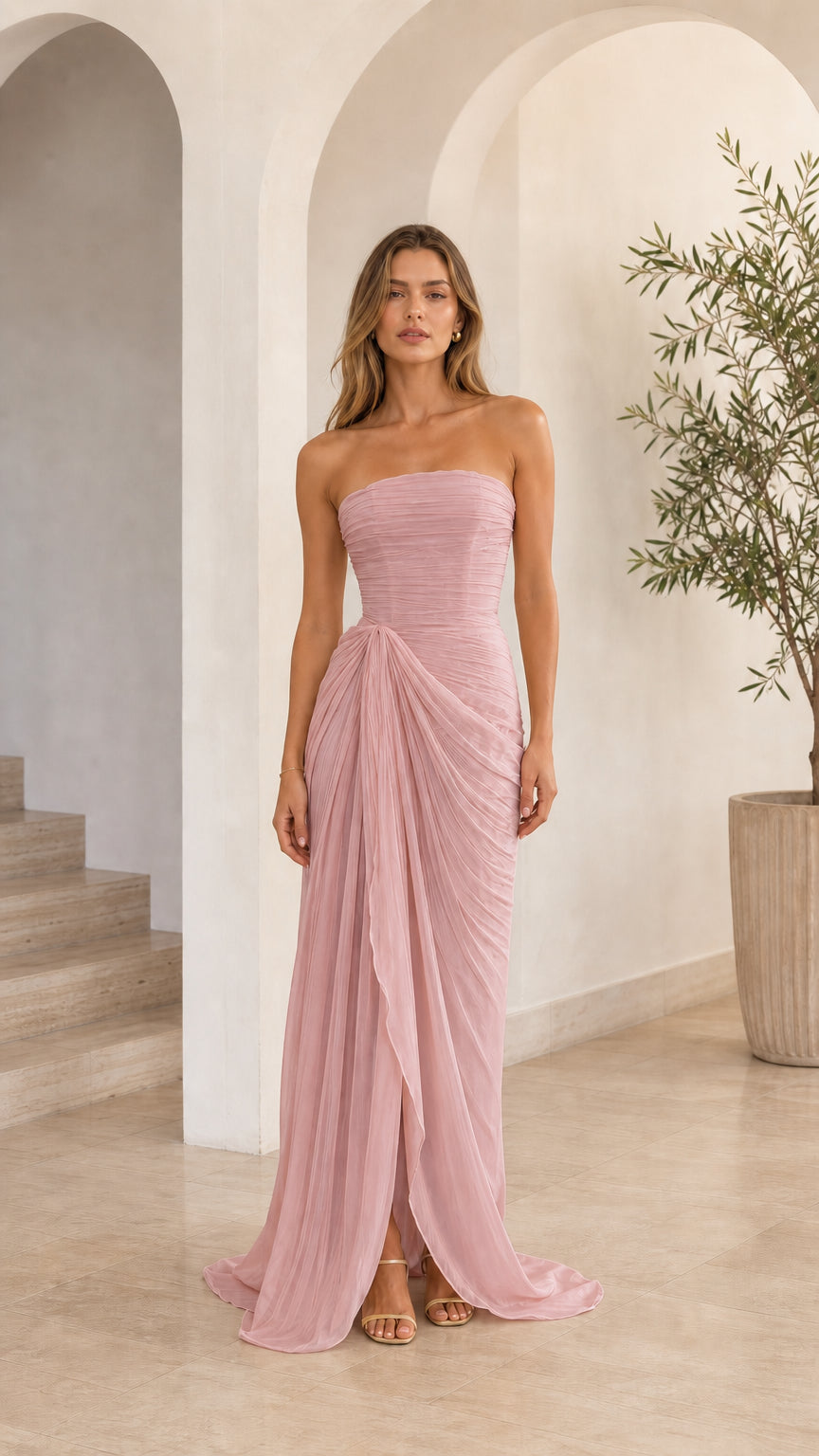 Model wearing dusty rose strapless draped corset maxi dress