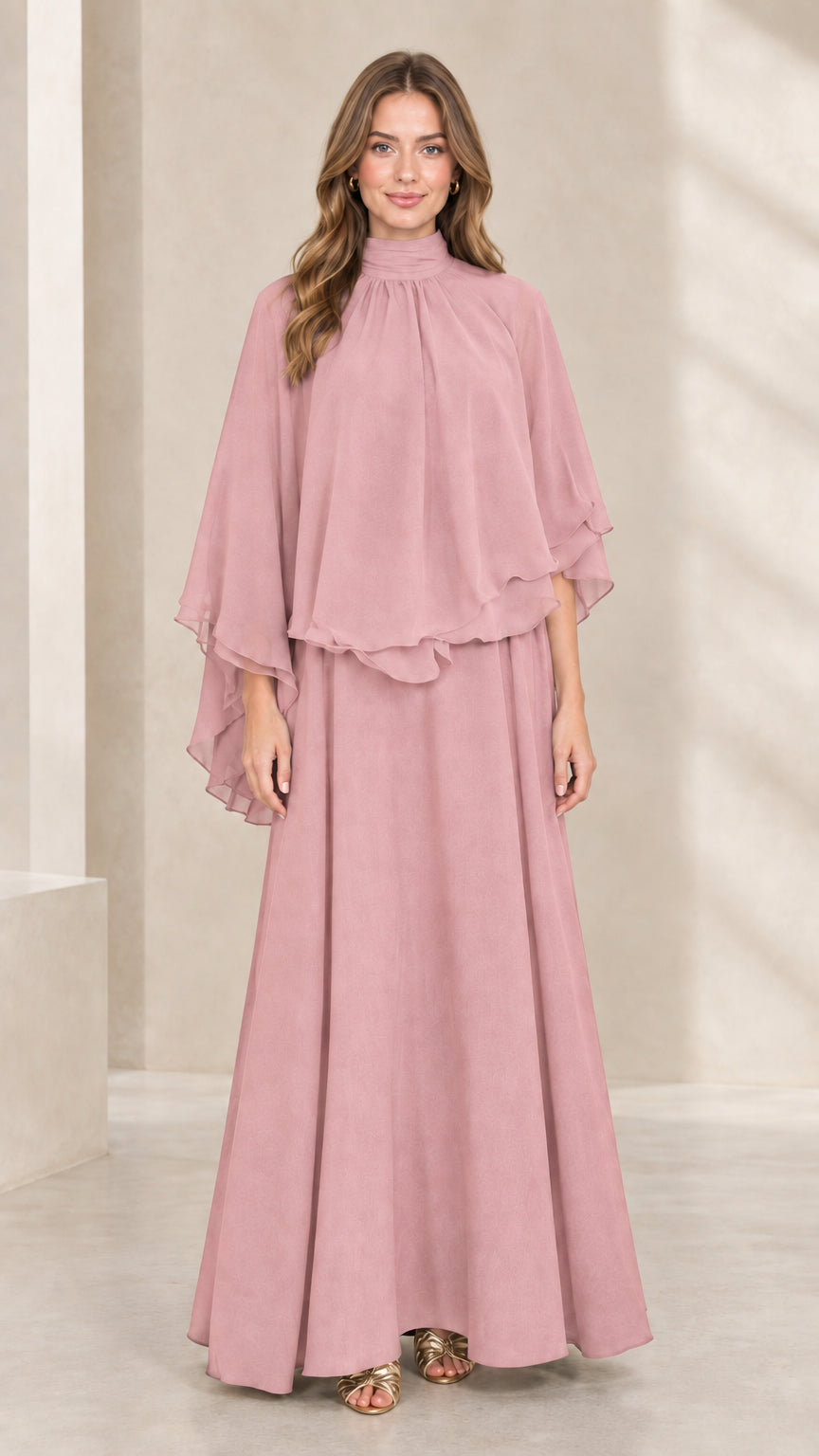 Front view of woman wearing dusty pink mock neck capelet maxi dress