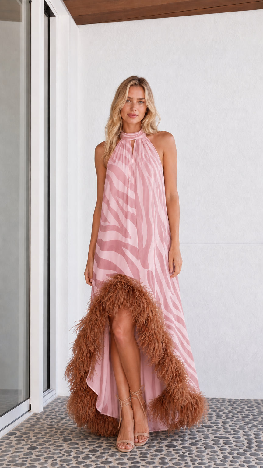 Model wearing pink zebra print maxi dress with feather hem
