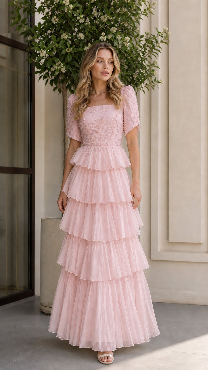 Blush pink tiered tulle evening gown with embroidered short sleeve bodice