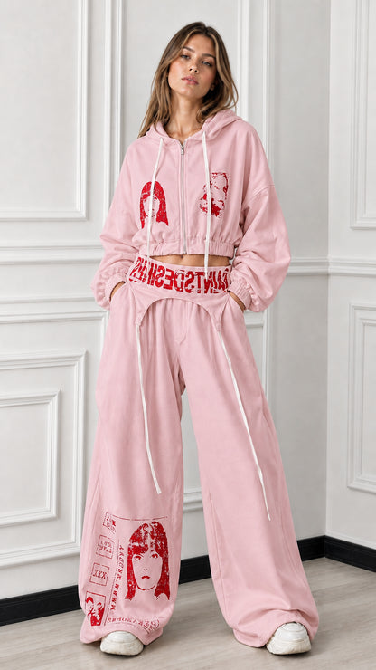 Full front view of soft pink 2-piece cropped zip hoodie and wide-leg graphic sweatpants set