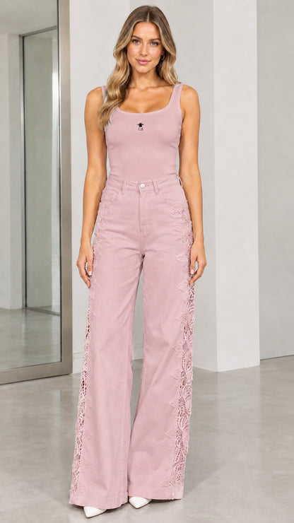 Front view of model wearing dusty pink high-waisted wide-leg pants with lace side trim