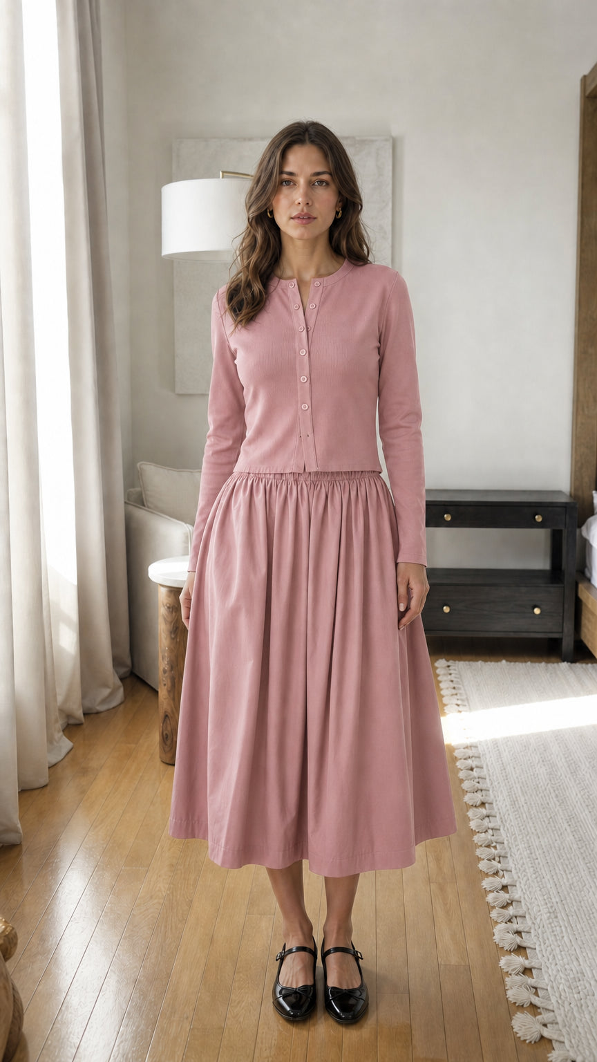 Woman wearing pink long-sleeve ribbed top and midi skirt set