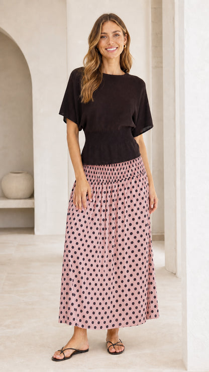 Front view of short sleeve knit bodice dress with dusty pink polka dot skirt