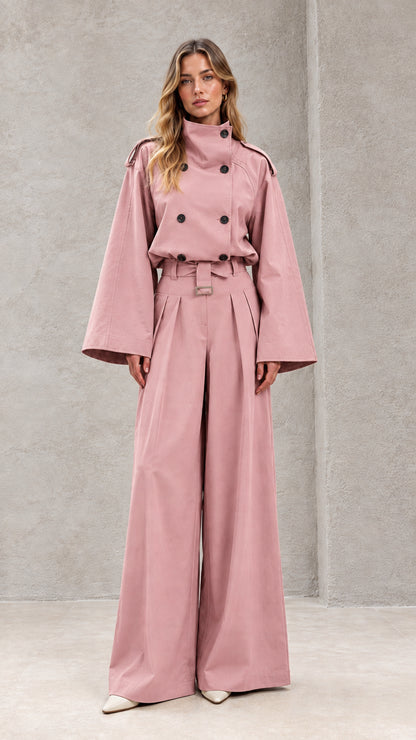 Front full-length view of model in dusty pink double-breasted wide-leg trench jumpsuit