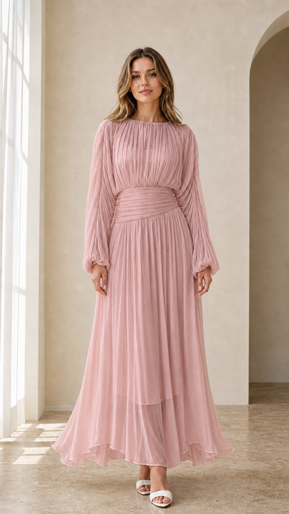 Model wearing dusty pink long sleeve pleated maxi dress