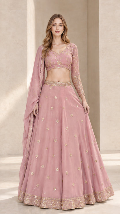 Front full view of dusty pink embroidered lehenga choli set with matching dupatta