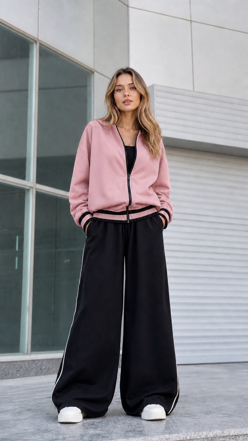 Model wearing dusty pink zip bomber jacket with black wide leg pants