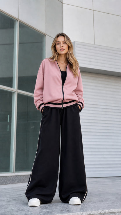 Model wearing dusty pink zip bomber jacket with black wide leg pants