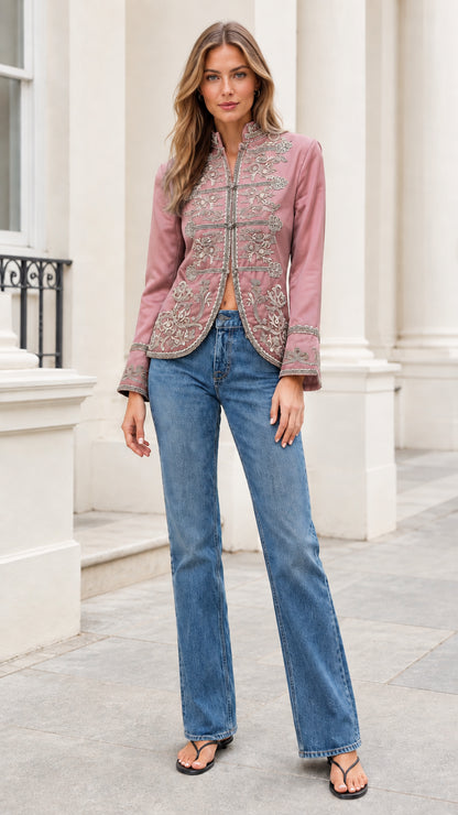 Model wearing dusty rose pink embroidered stand collar jacket with blue jeans