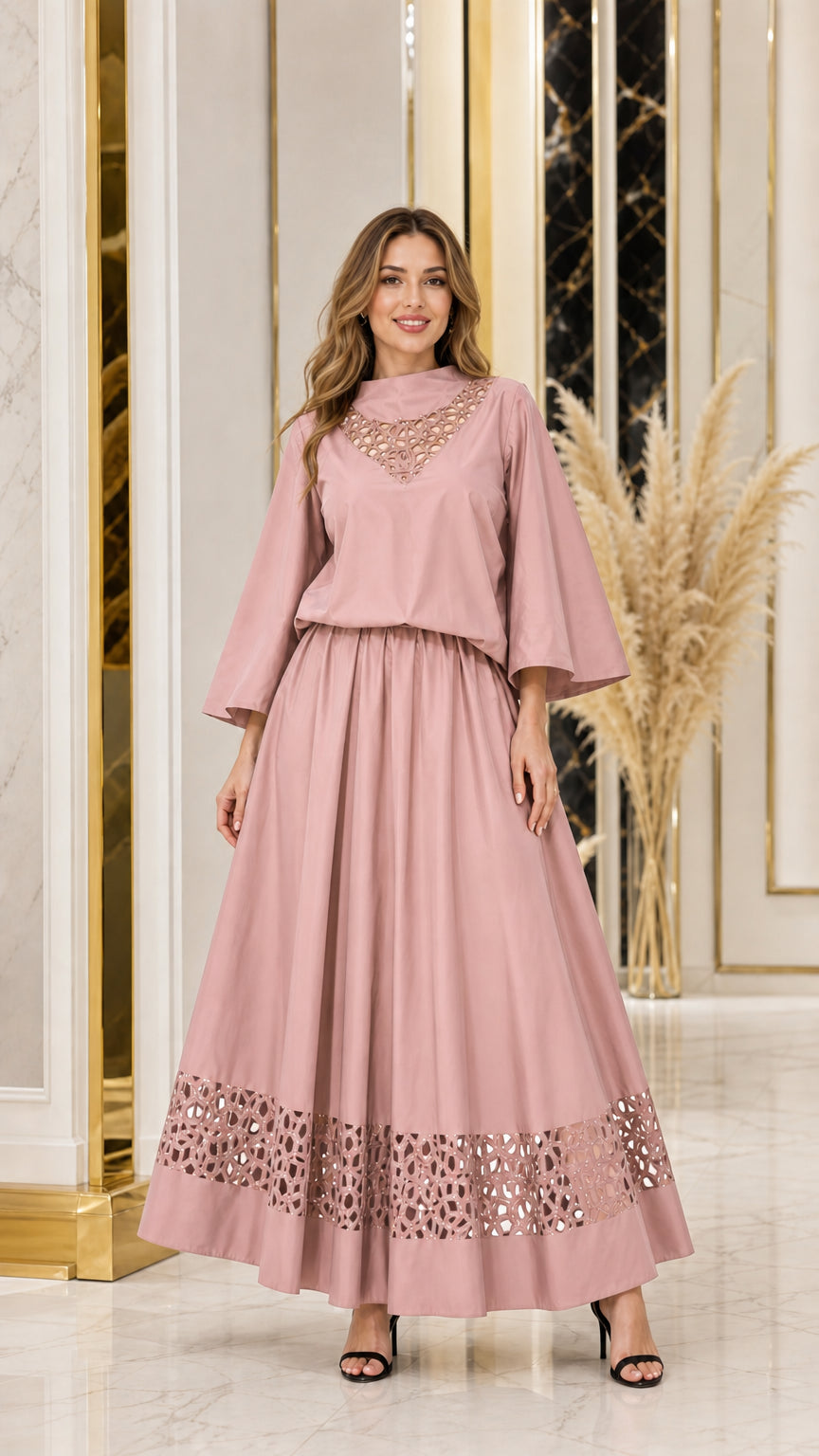 Woman wearing dusty pink cutout neckline top and matching maxi skirt