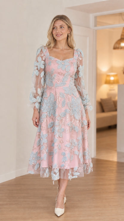 Front view of model in pink floral applique midi dress