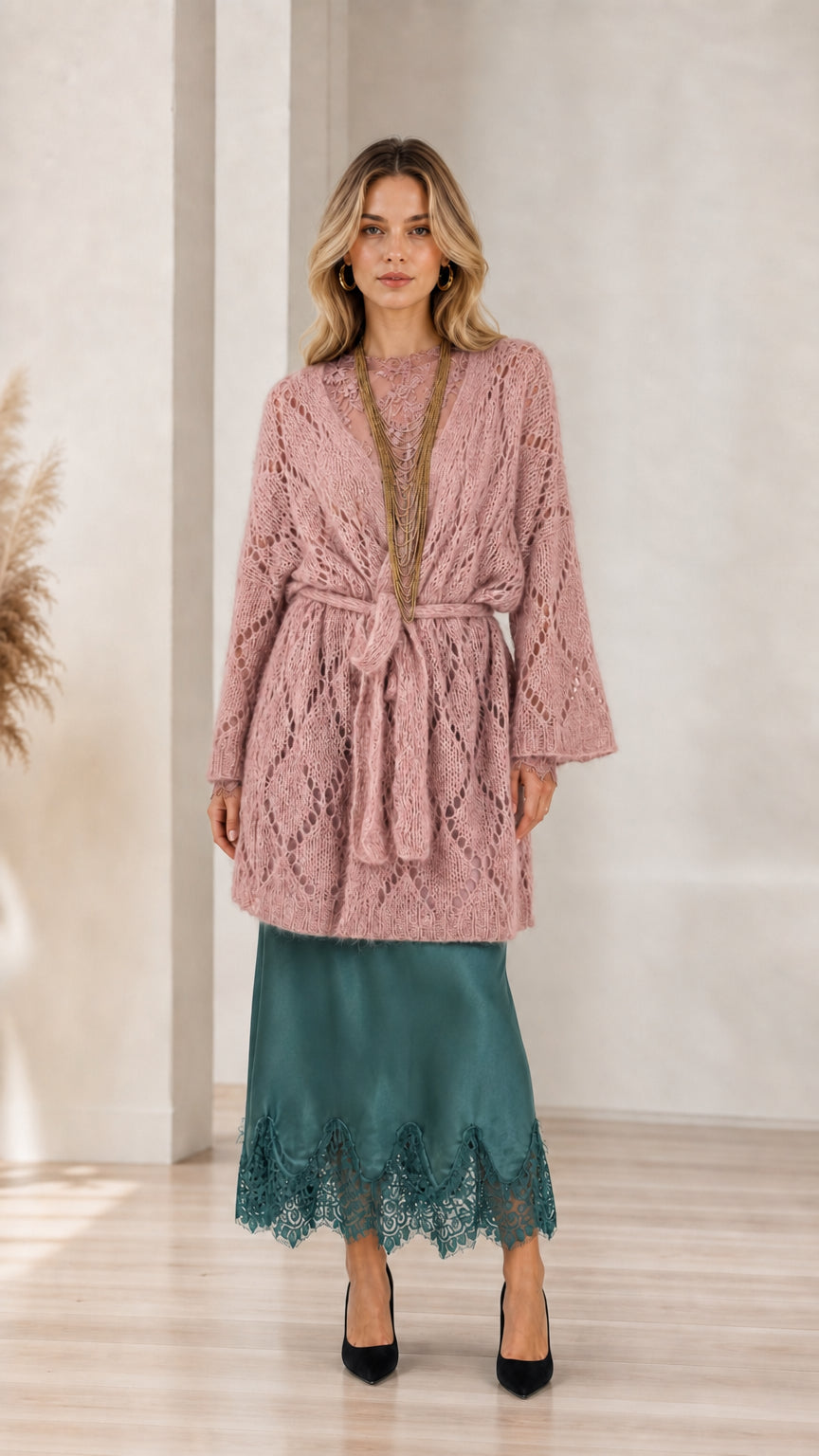 Model wearing pink open front knit cardigan with belt