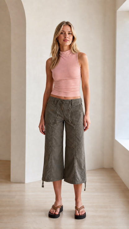 Model wearing dusty pink fitted mock neck sleeveless tank top